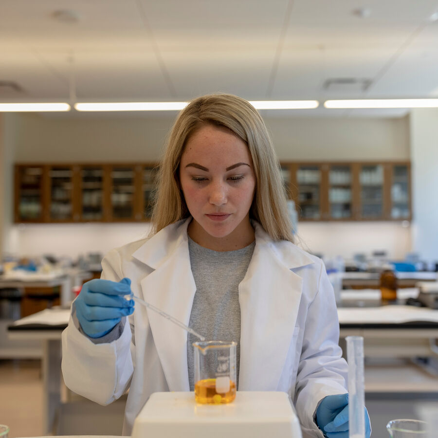 A female student analyzes a sample in a laboratory at the UT Tyler Fisch College of Pharmacy