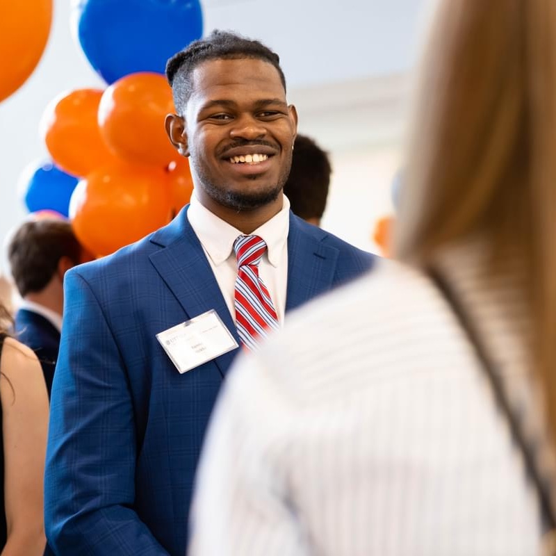 A male UT Tyler student at a networking event