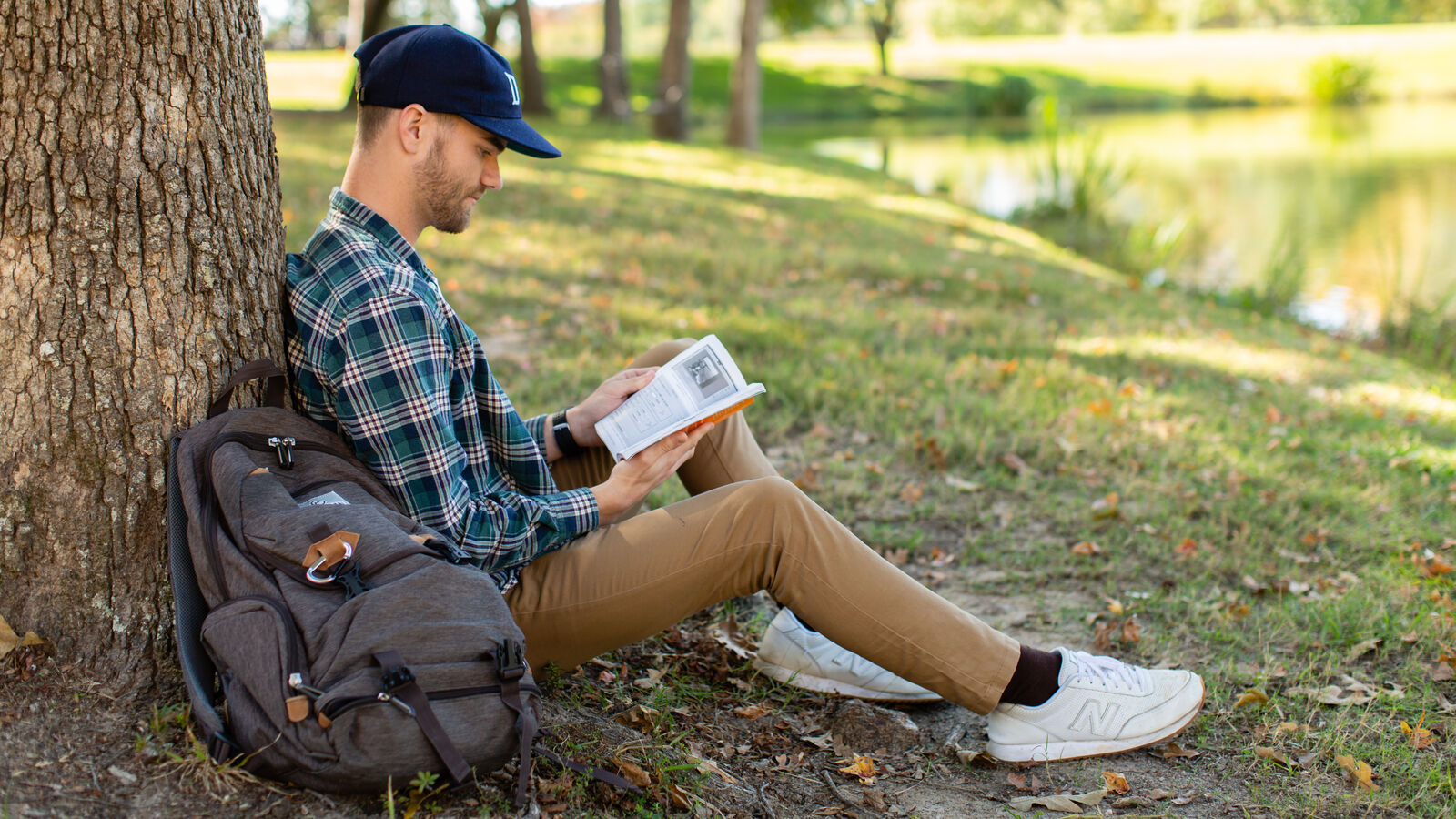 A male English student reads by Harvey Lake at The University of Texas at Tyler