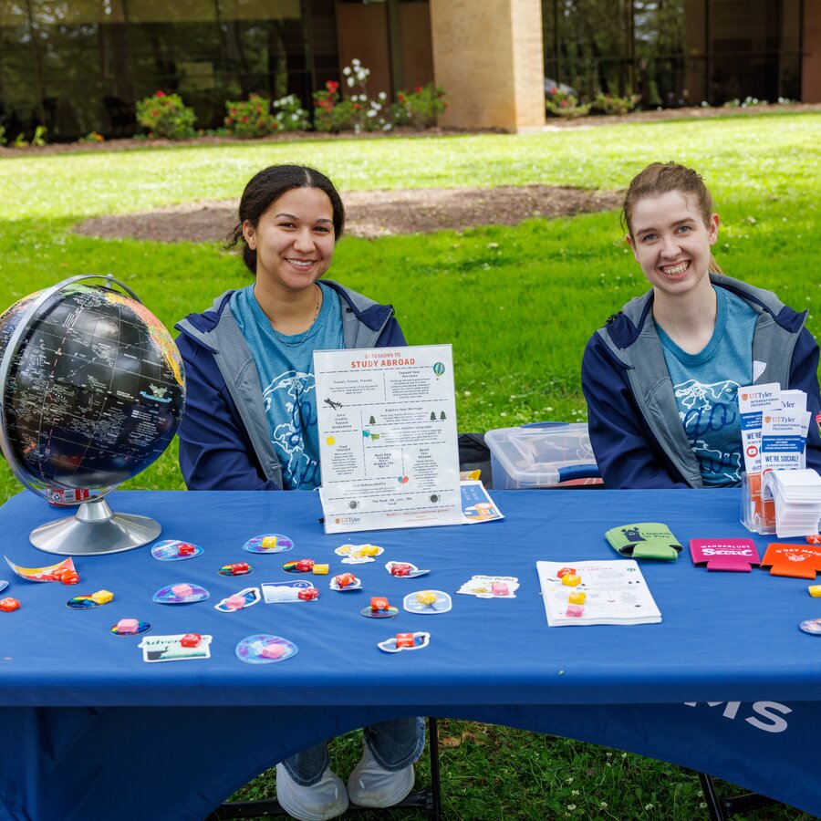 Students sitting at a table promoting study abroad