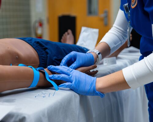 A student trains on taking blood at SMILE (simulation lab on north campus) at a collaboration event between the School of Medicine, School of Nursing and the Fisch College of Pharmacy.