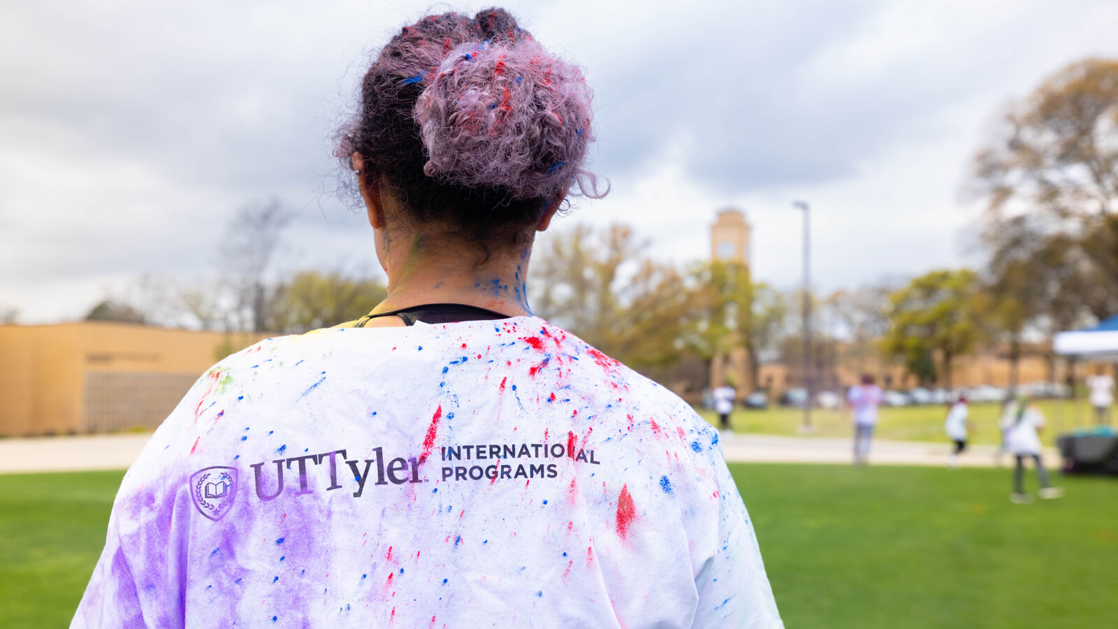 A student participates in a Holi celebration on the plaza, hosted by UT Tyler's Office of International Programs