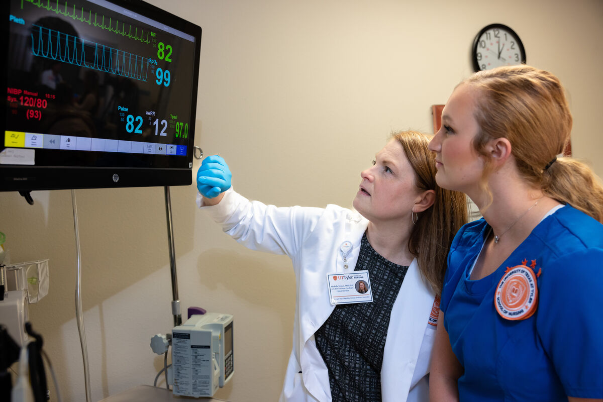 A pair of nursing students observing a heartrate monitor