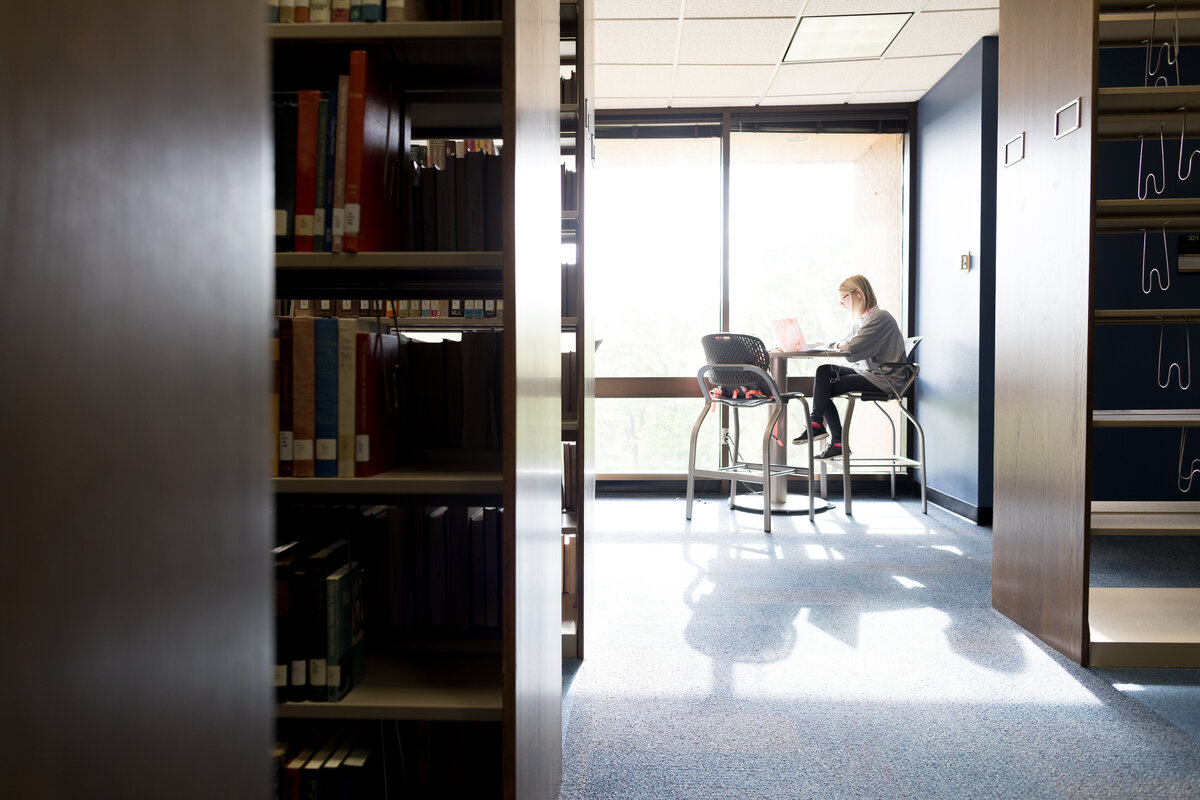 A student studying in the Robert R. Muntz library