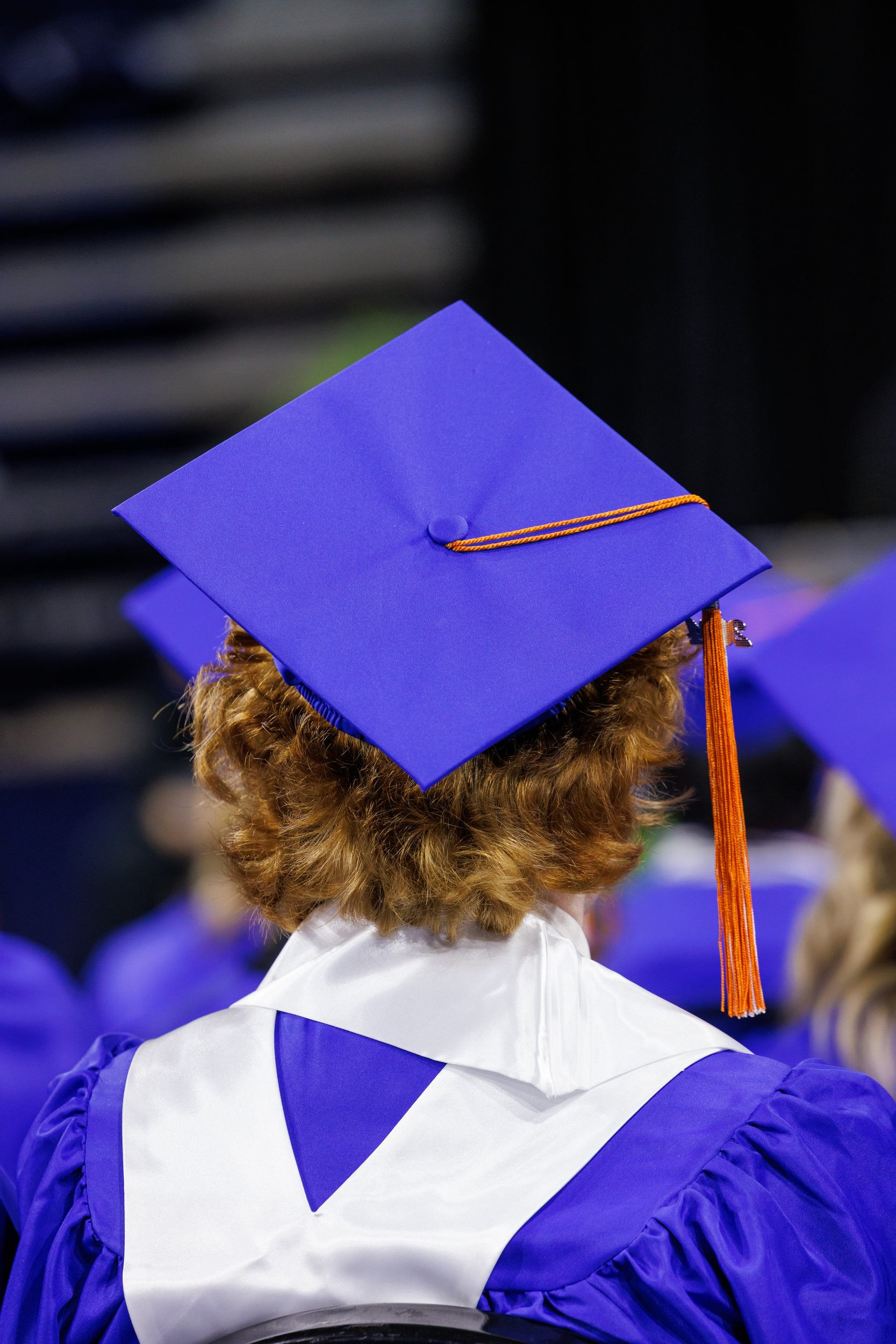 A Universiy Academy senior in cap and gown during graduation ceremony