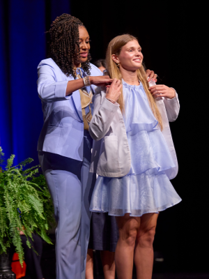 First-Year Medical Student Samantha Schott: Schott dons a white coat as part of the UT Tyler School of Medicine's White Coat Ceremony, signifying the beginning of her medical profession.