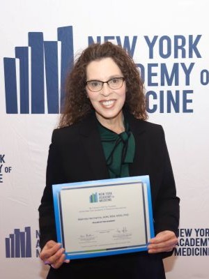 Dr. Melinda Hermanns being accepted into the New York Academy of Medicine
