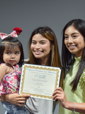 Nurse Family Partnership program graduates, Bliss Cordova and her daughter, receive their certificate from Laura Vazquez, their nurse during the program. The nurses monitor the child’s weight, blood pressure, length, head circumference and temperature, to prevent serious health issues or help the mother access the right resources if problems arise.
