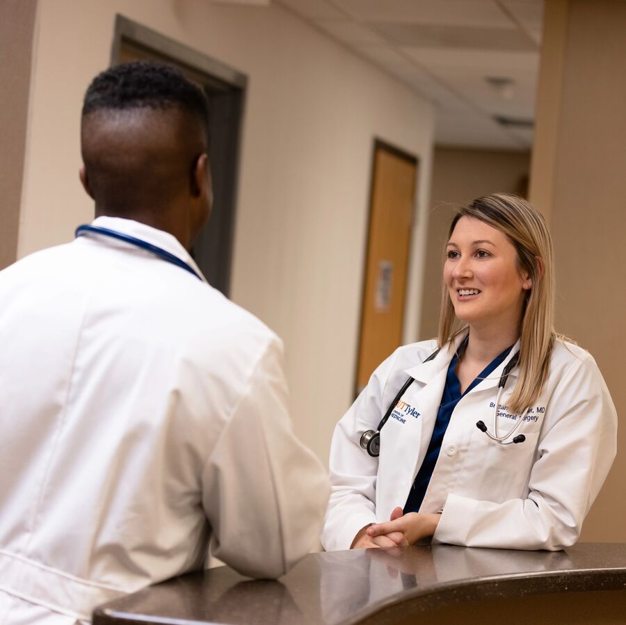 Two residents lean against a desk at the UT Tyler Health Science Center