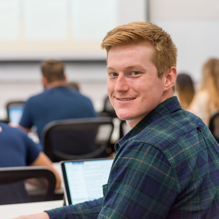 UT Tyler student in lecture smiling