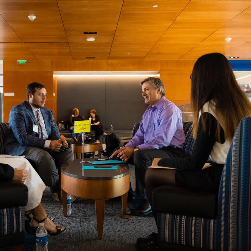 UT Tyler students sitting around a table with a mock interviewer