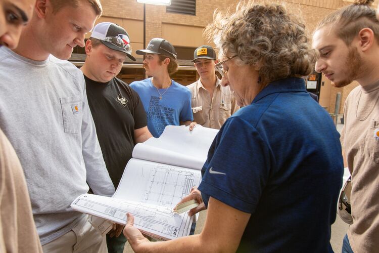 Construction Management team looking at book