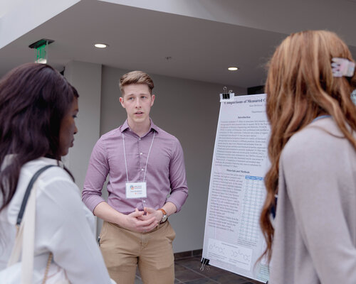 Male student presenting at the East Texas Research Conference in 2023.