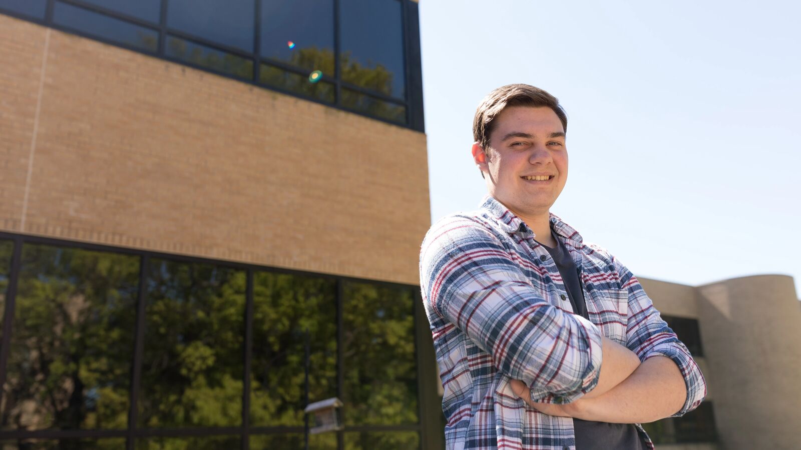 A male social sciences student stands outdoors at The University of Texas at Tyler