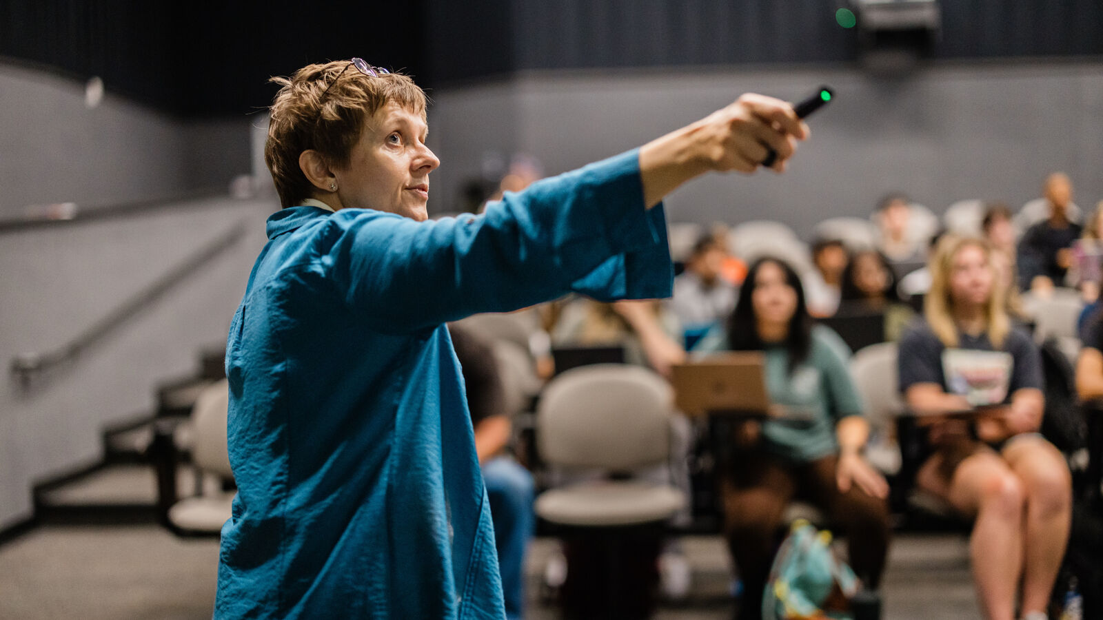 A female lecturer holds up a pointer in UT Tyler's Art Department