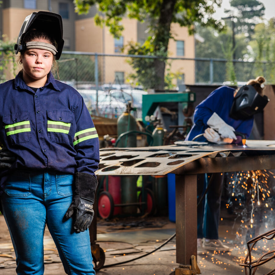 Two BFA students with welding helmets in UT Tyler's Art Department