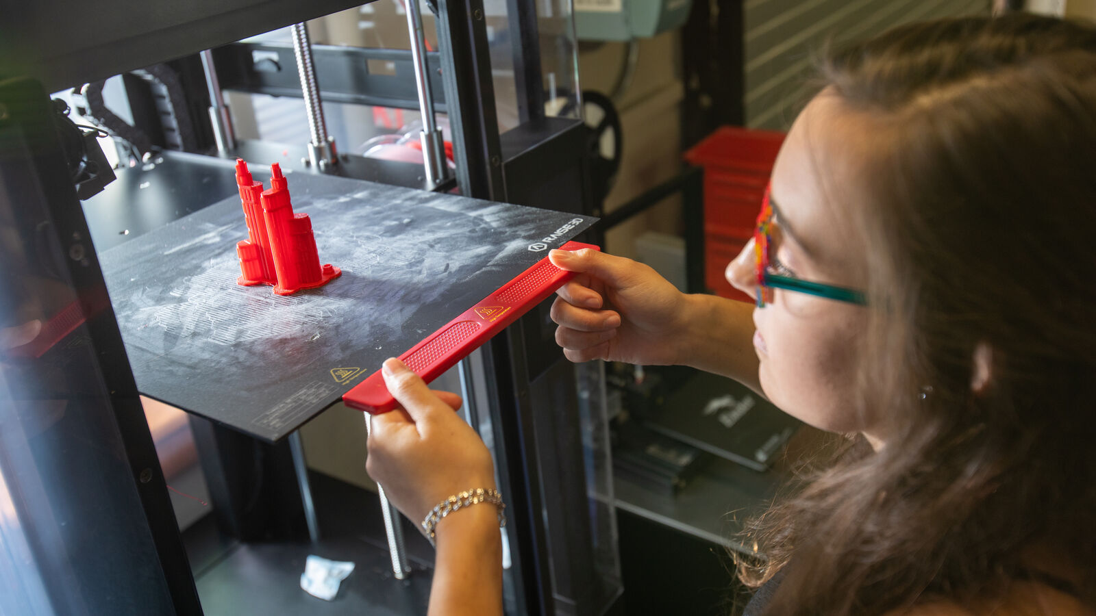 A female civil engineering student at The University of Texas at Tyler uses equipment in the Ratliff Building South.