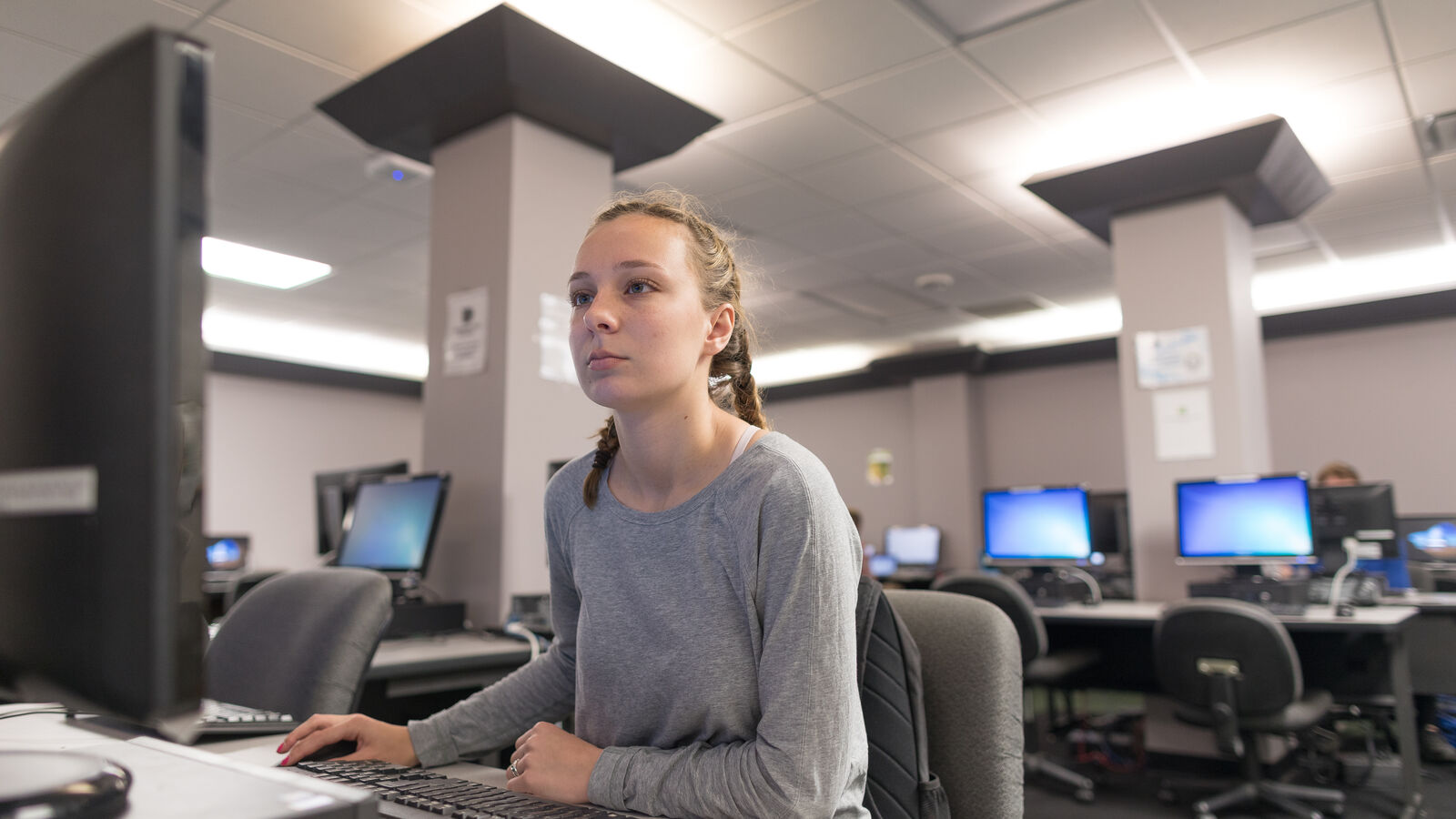 A female information technology student in a computer lab at The University of Texas at Tyler