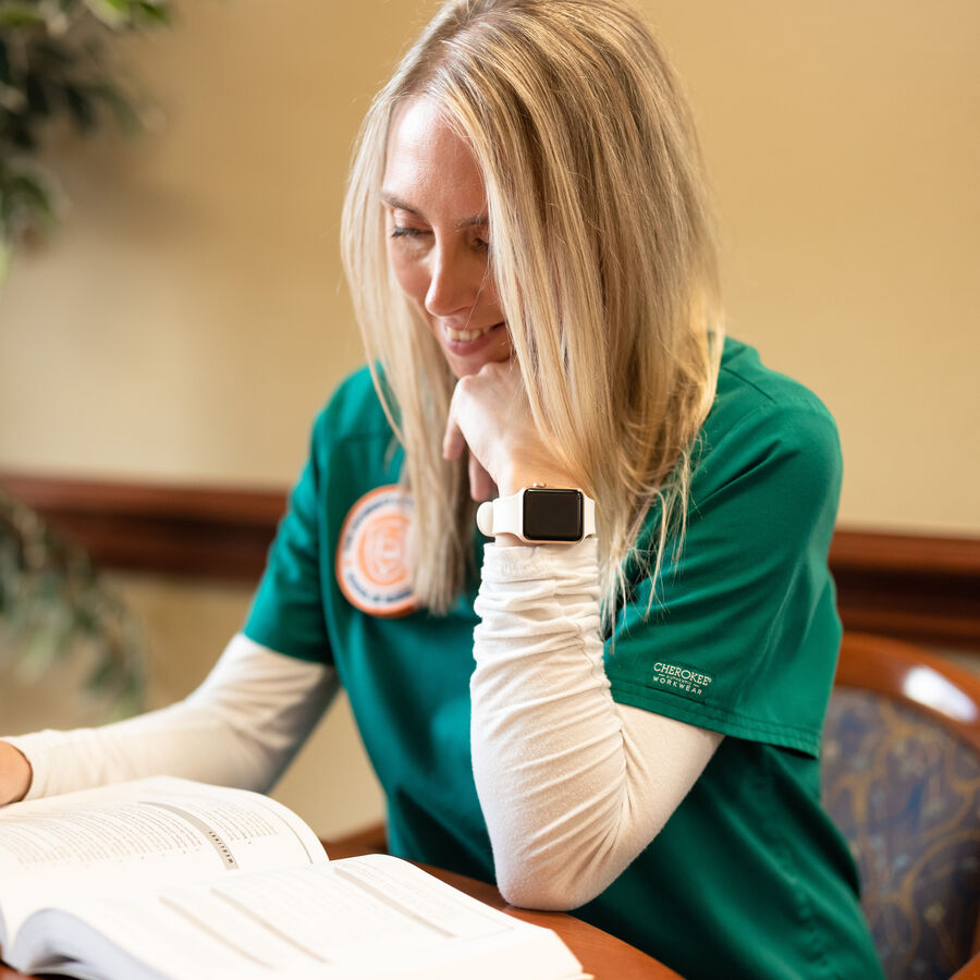 A female BSN student at UT Tyler studies at a table