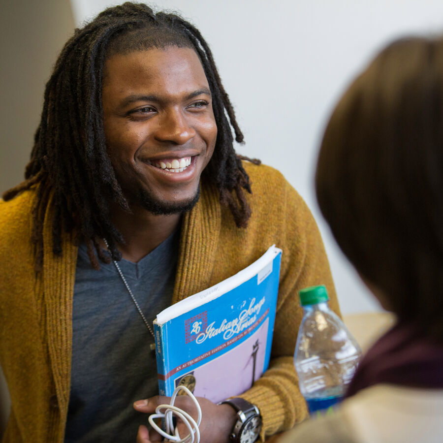 A smiling male student in class in UT Tyler's College of Arts and Sciences