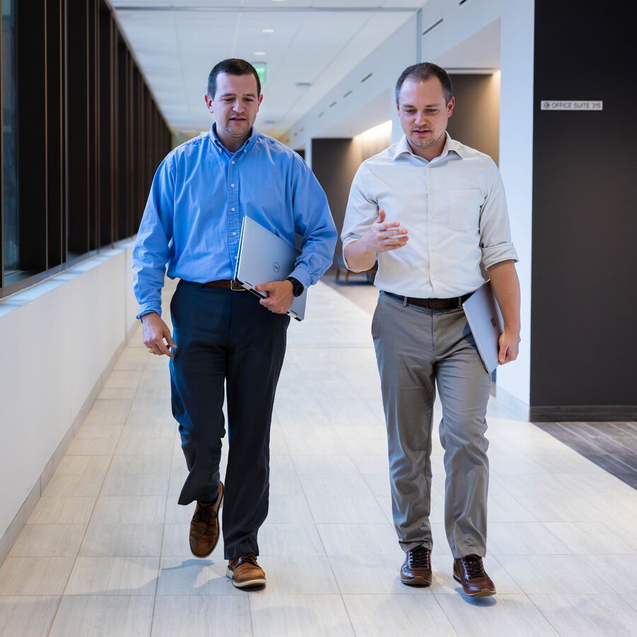 Two health professionals walking down the hallway of a hospital