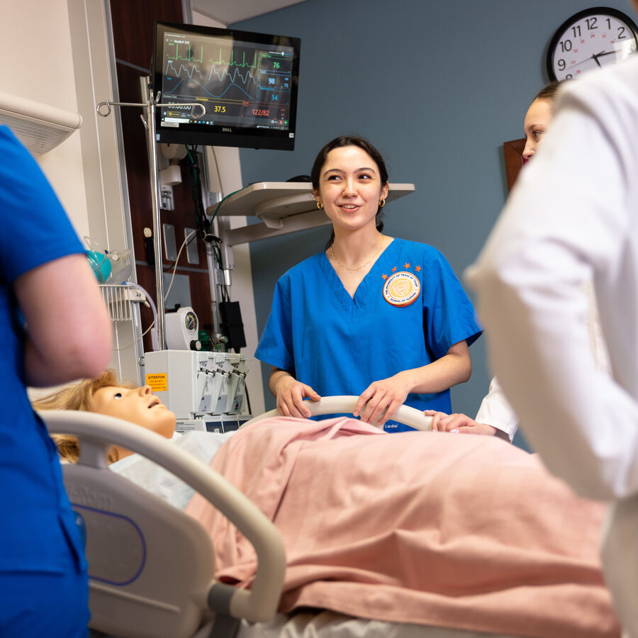 Female School of Nursing students at UT Tyler practice patient care in a simulated environment