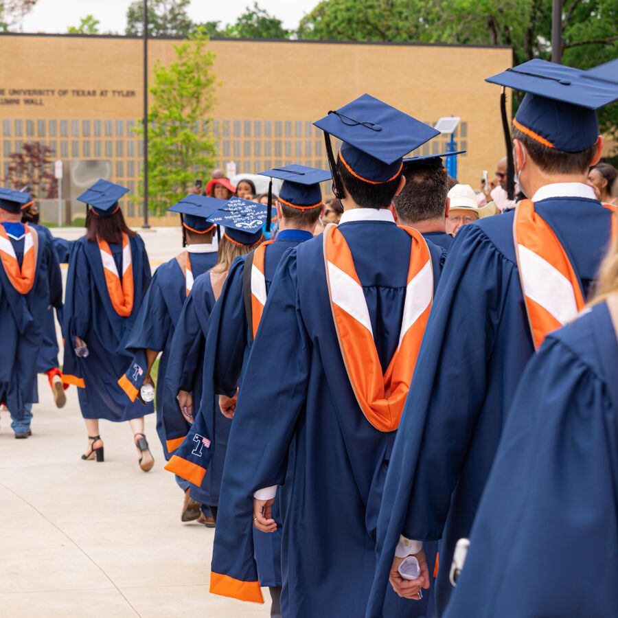 Graduate students from The University of Texas at Tyler's College of Education and Psychology wait in line at convocation