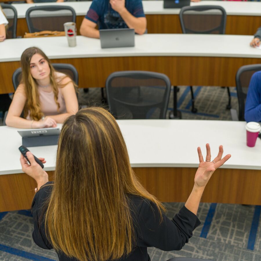 A female faculty member lectures a classroom of Soules College of Business students at UT Tyler