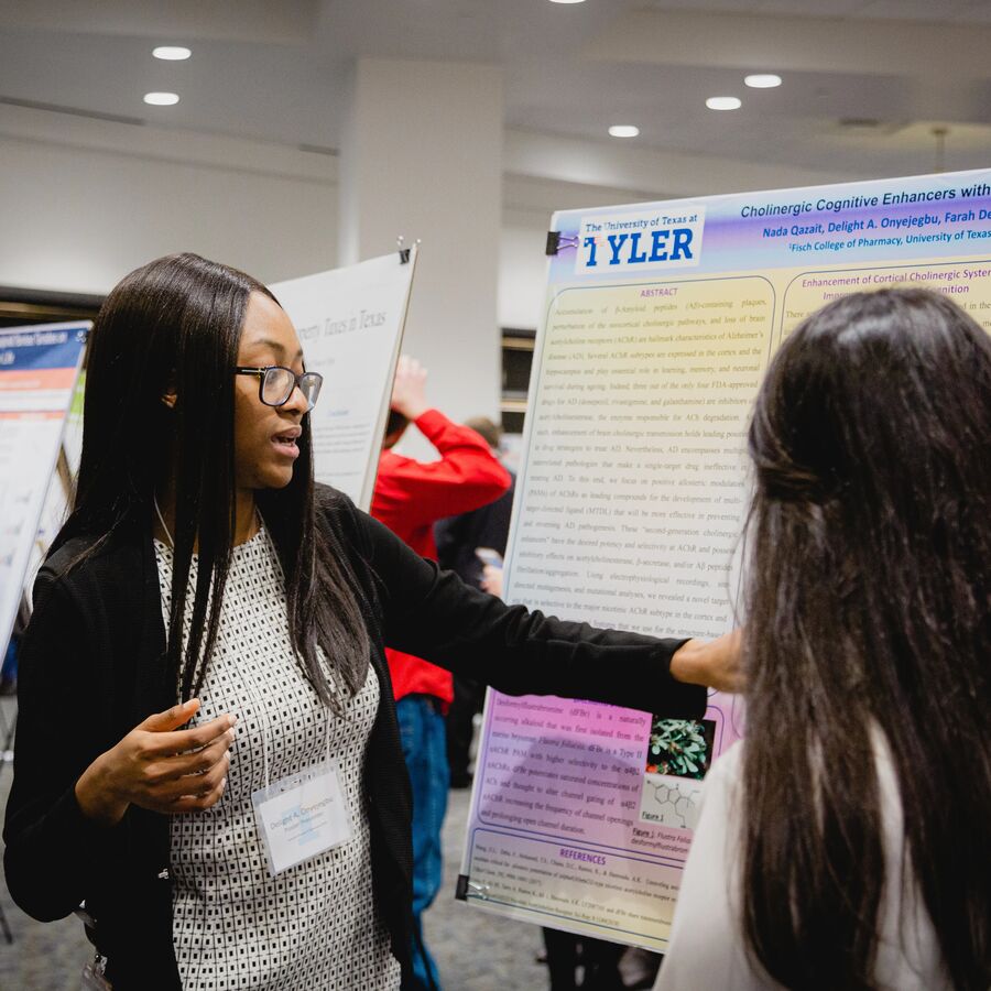A female student presents her research at Lyceum, UT Tyler's Honors Research symposium