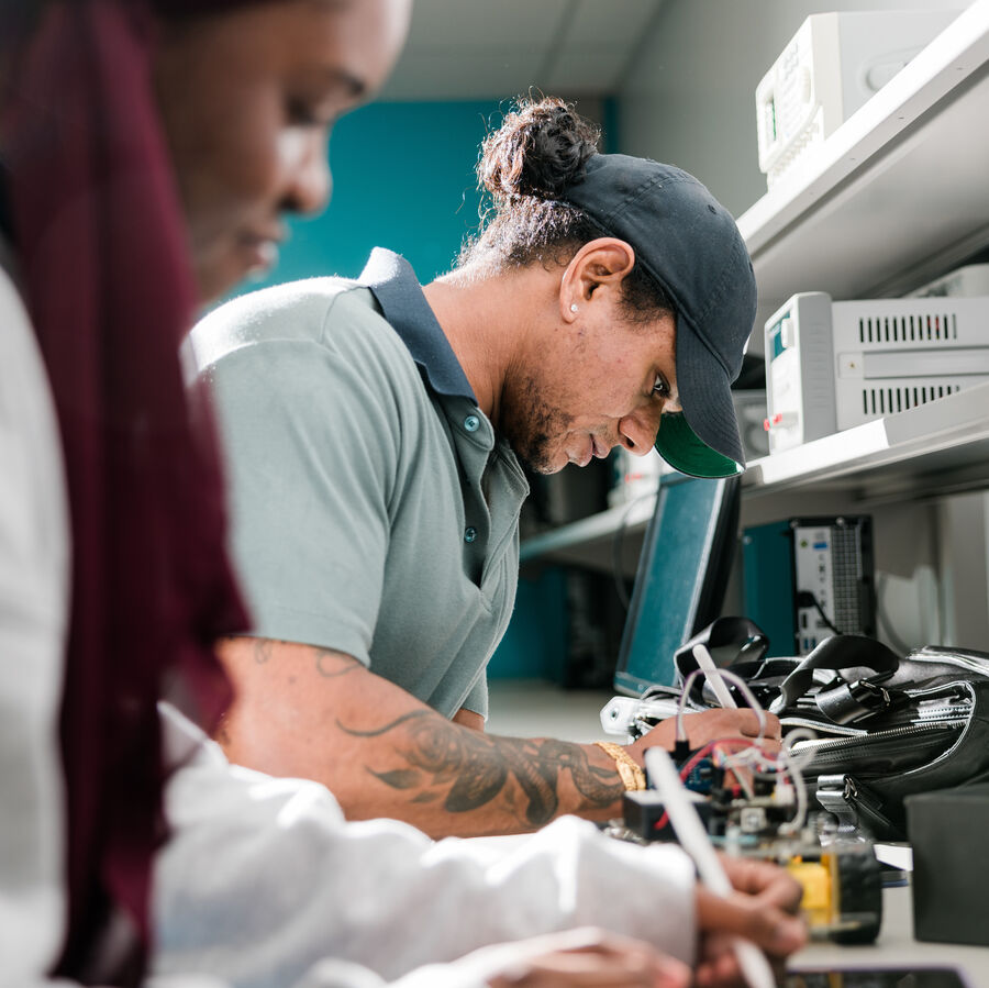 Two students work on electrical components in a classroom at UT Tyler's Houston Engineering Center