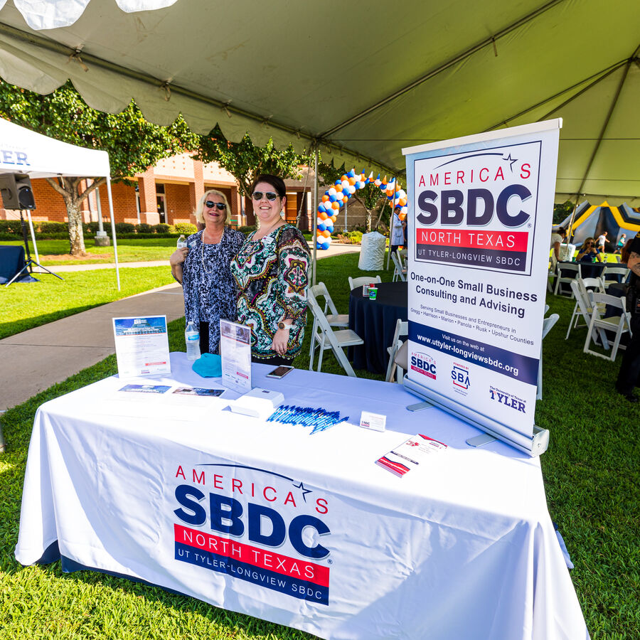 Two women tabling for the Small Business Development Center at a UT Tyler Longview University Center Open House 