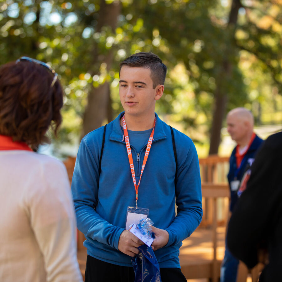A student guide talks to a group of parents and students during a campus tour of The University of Texas at Tyler