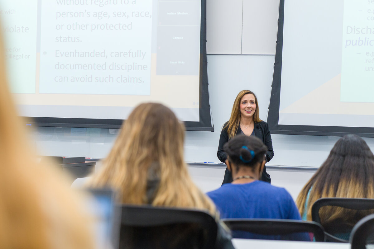 A professor is giving a lecture to a class of students