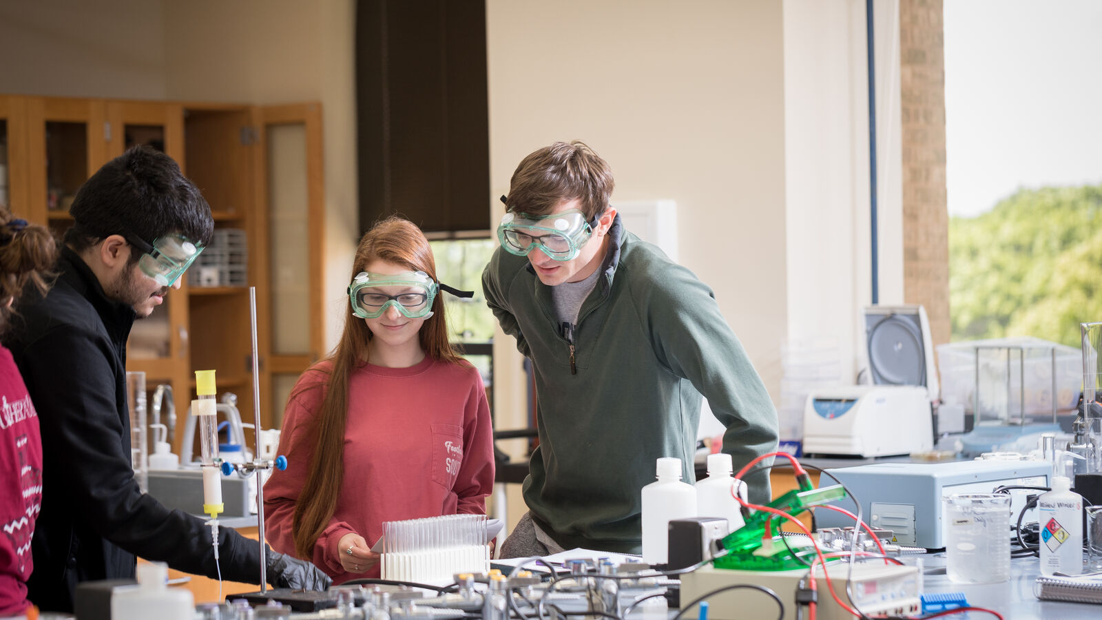 Chemistry students checking on a chemical reactor in the chemical engineering lab at UT Tyler