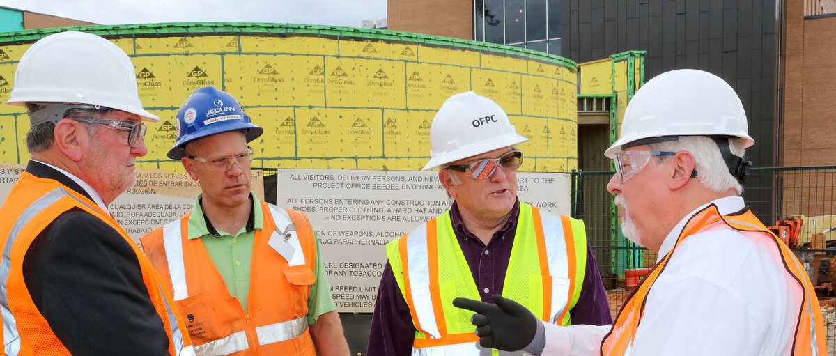 Four construction workers talking