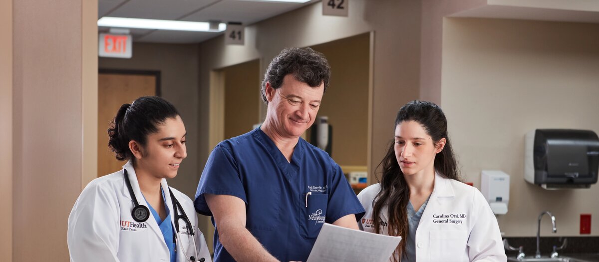 Two medicine students and a doctor