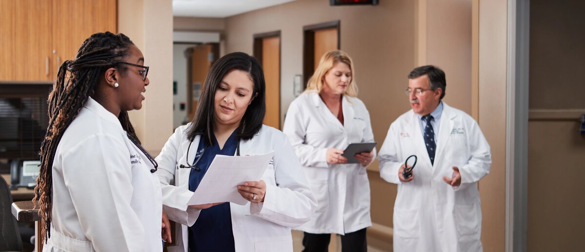 Four medicine students in a hospital