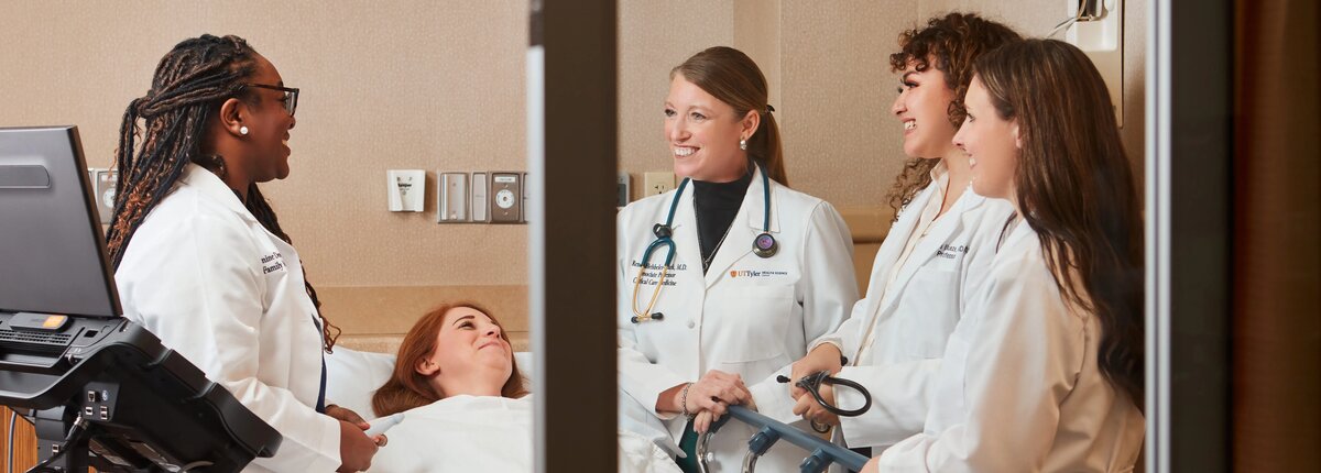 Medicine students around a hospital bed