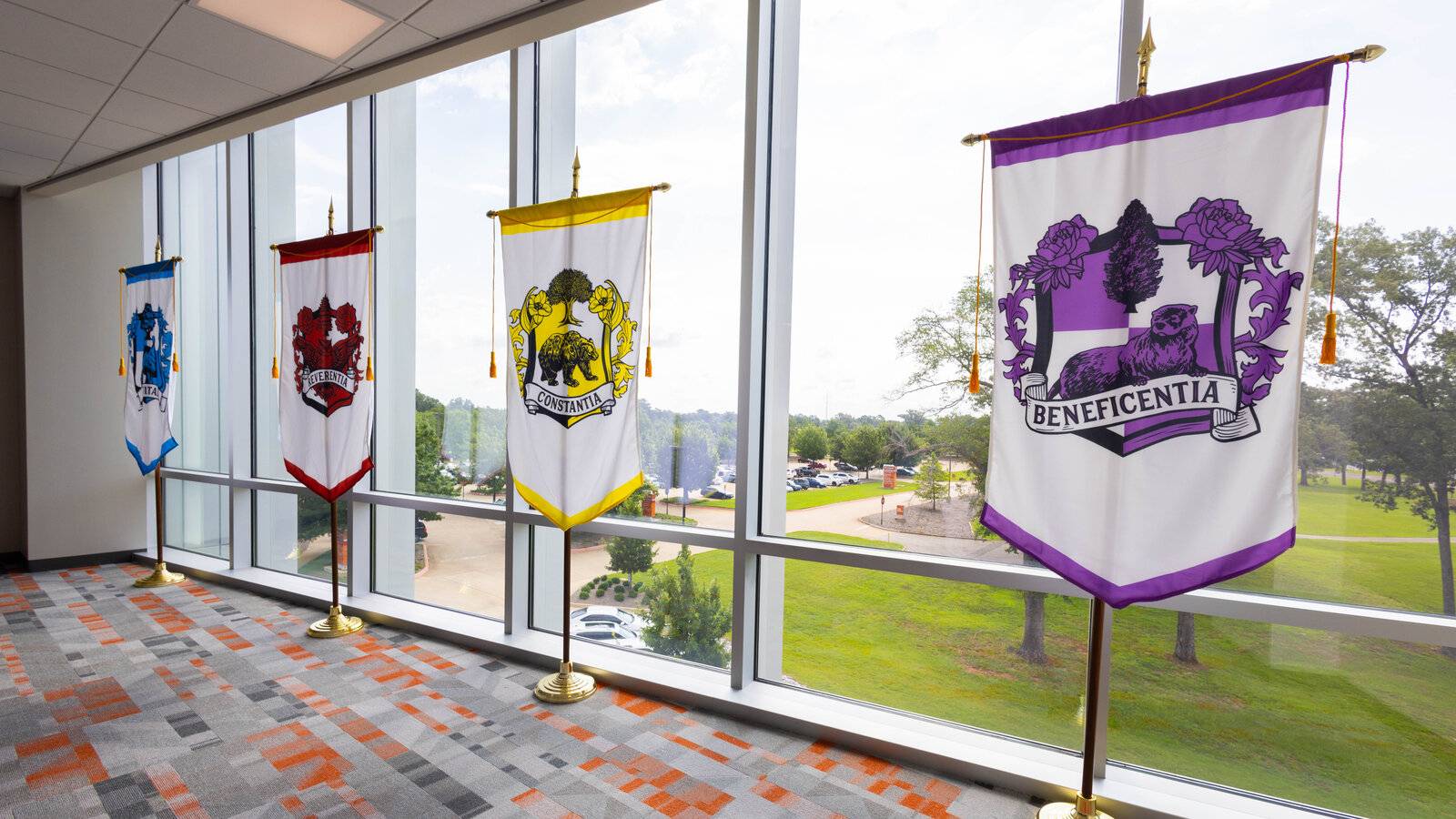 gonfalon banners displayed in a row representing each academic house