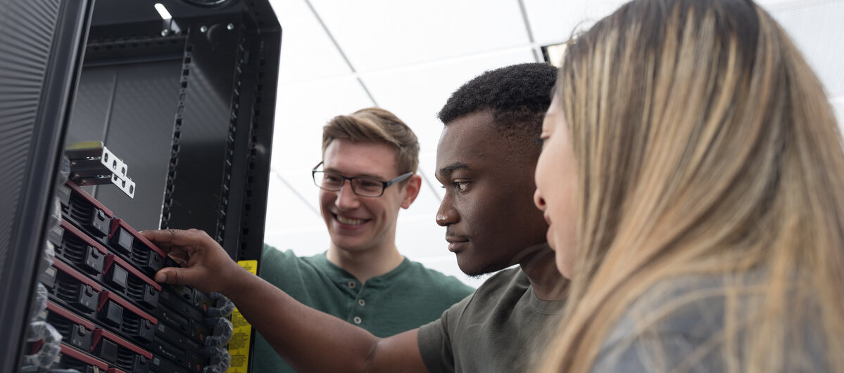 Students huddled around a computer