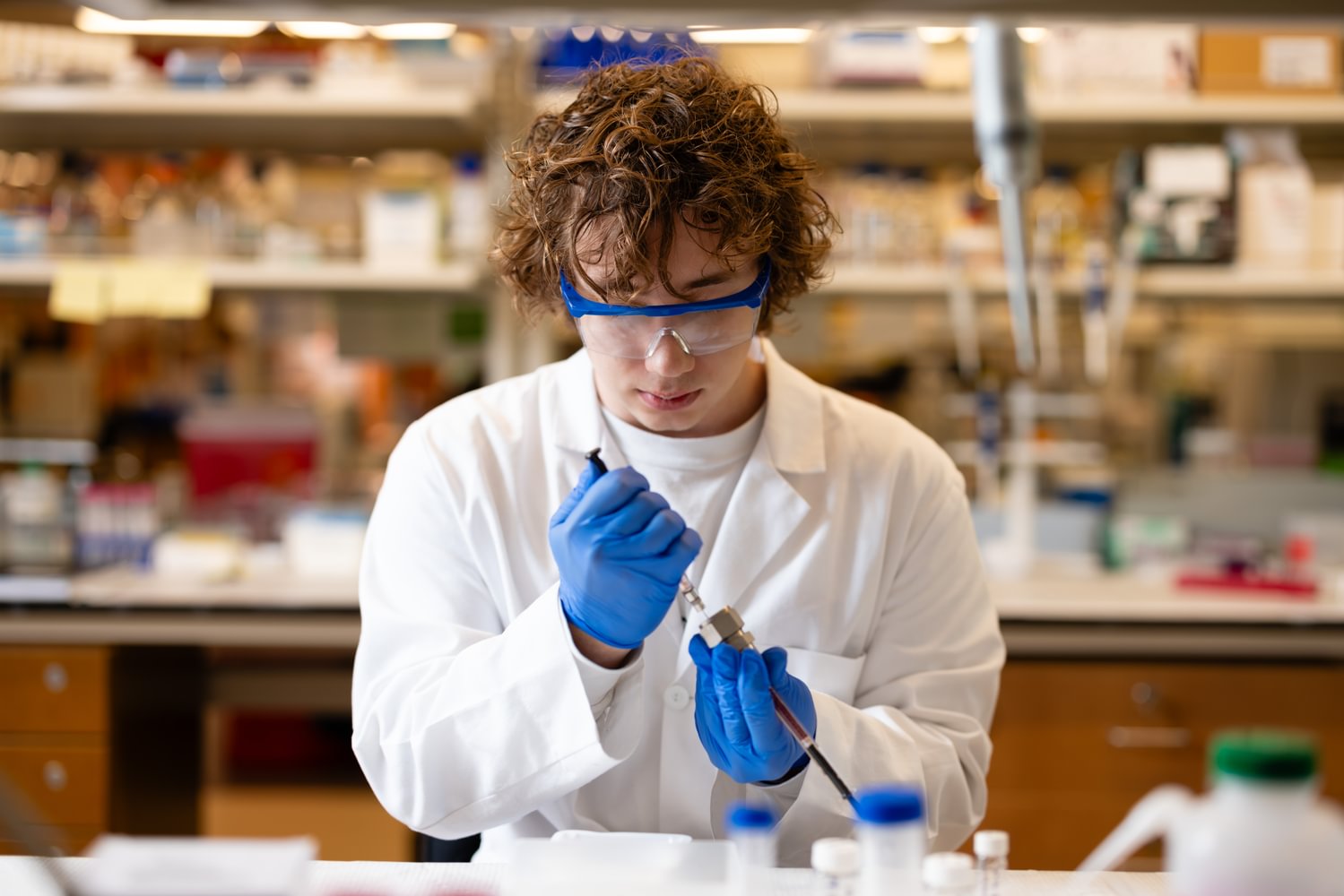 A male college of pharmacy student working in a lab