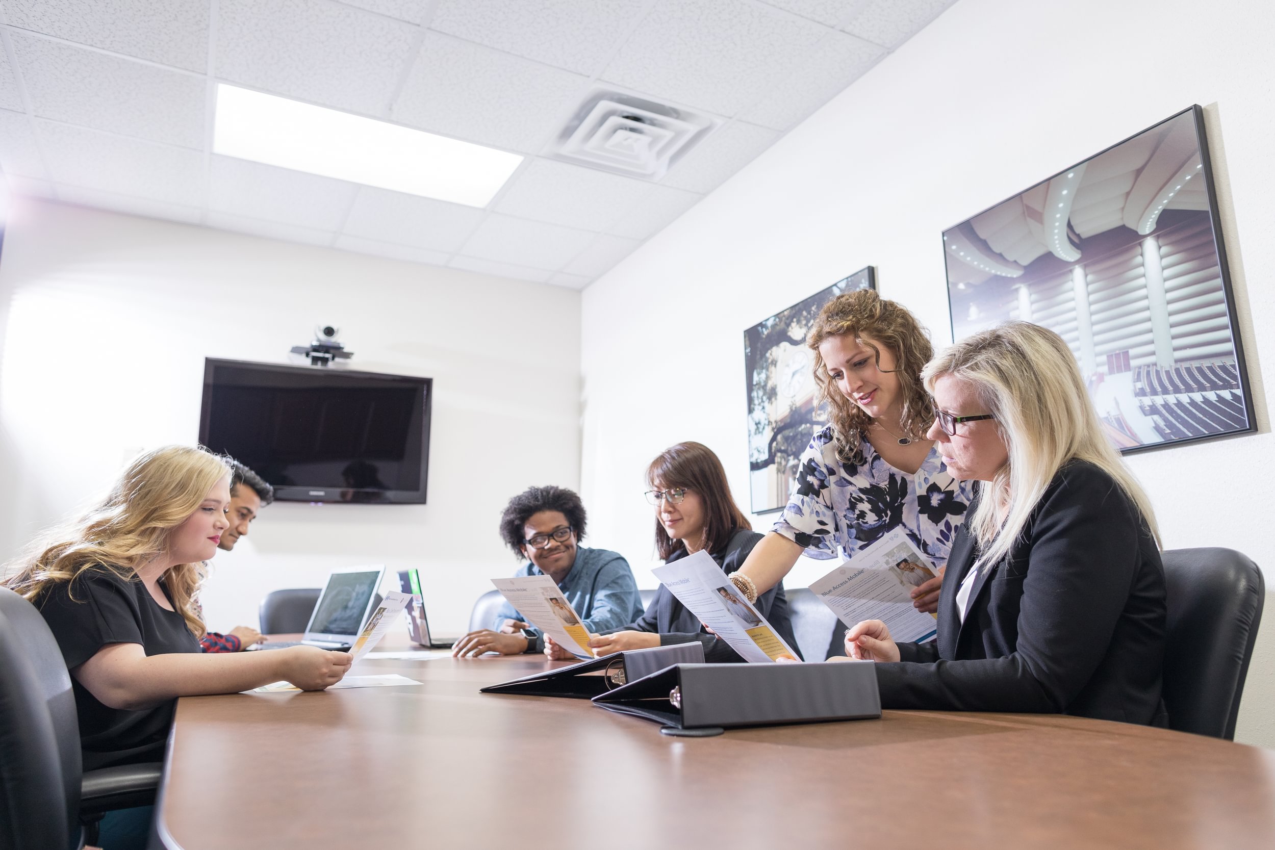 Faculty and students interacting in the Soules College of Business conference room