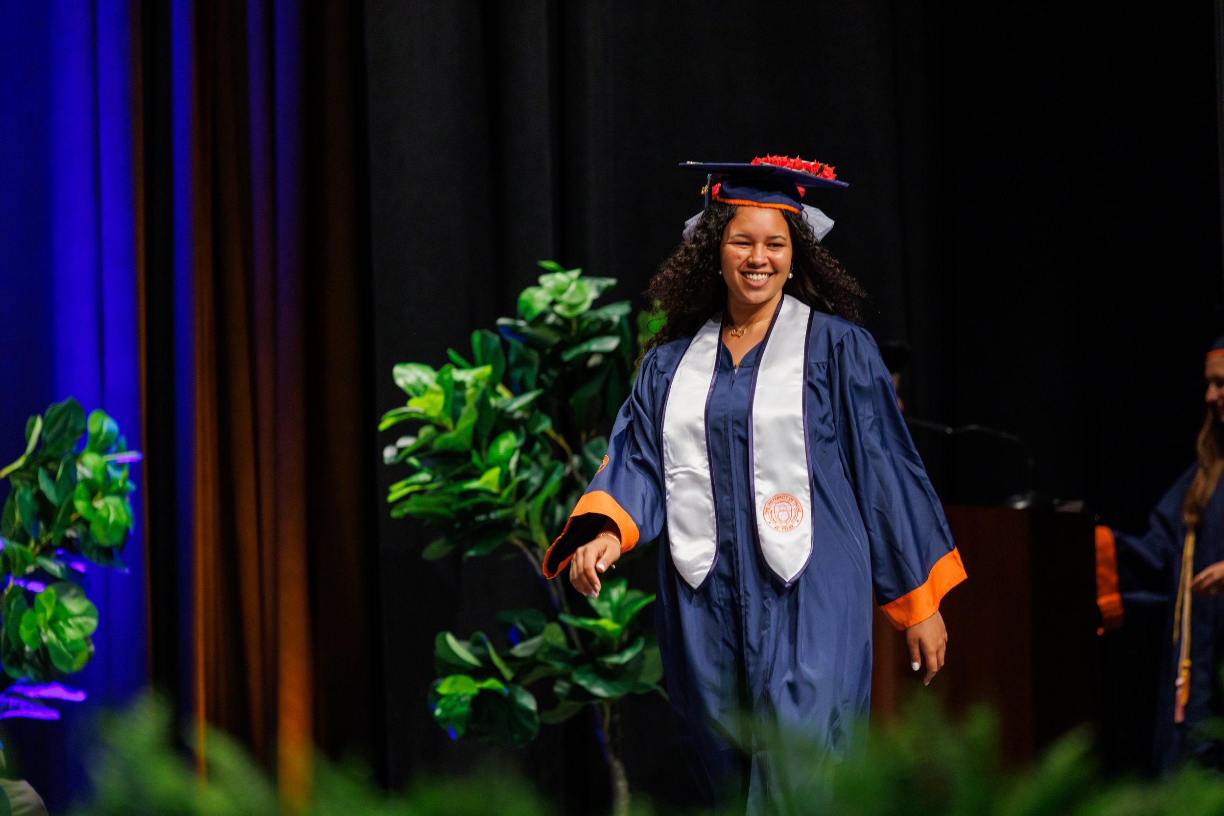 Degree candidate walking across stage at UT Tyler commencement ceremony