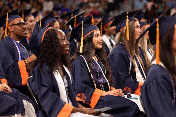 Photo of graduating students participating in commencement ceremony at the Herrington Patriot Center