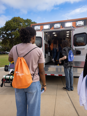Photo of students in front of an ambulance on campus during the 2024 Pre-Health Conference