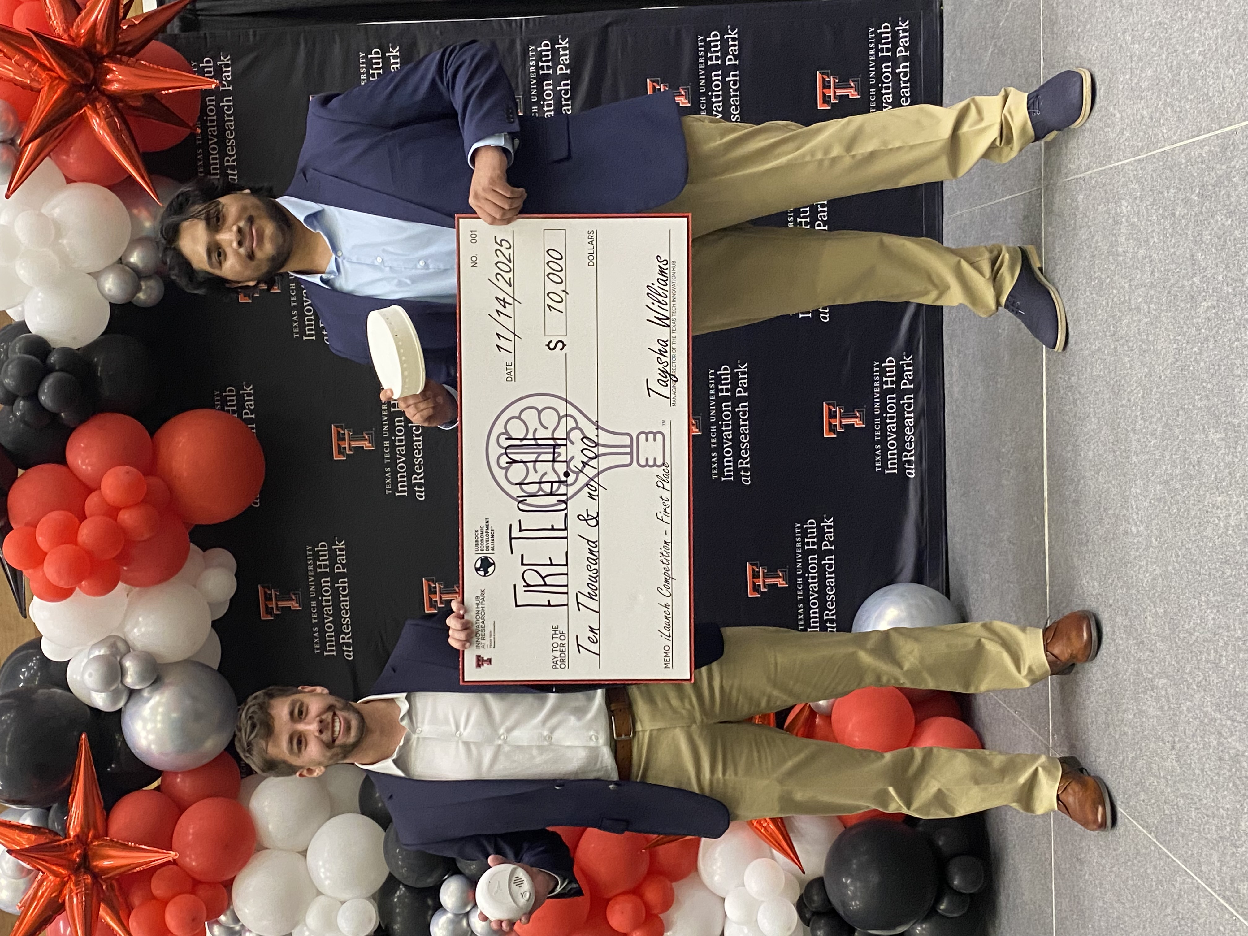 UT Tyler FireAI team leaders at regional iLaunch competition with prize check