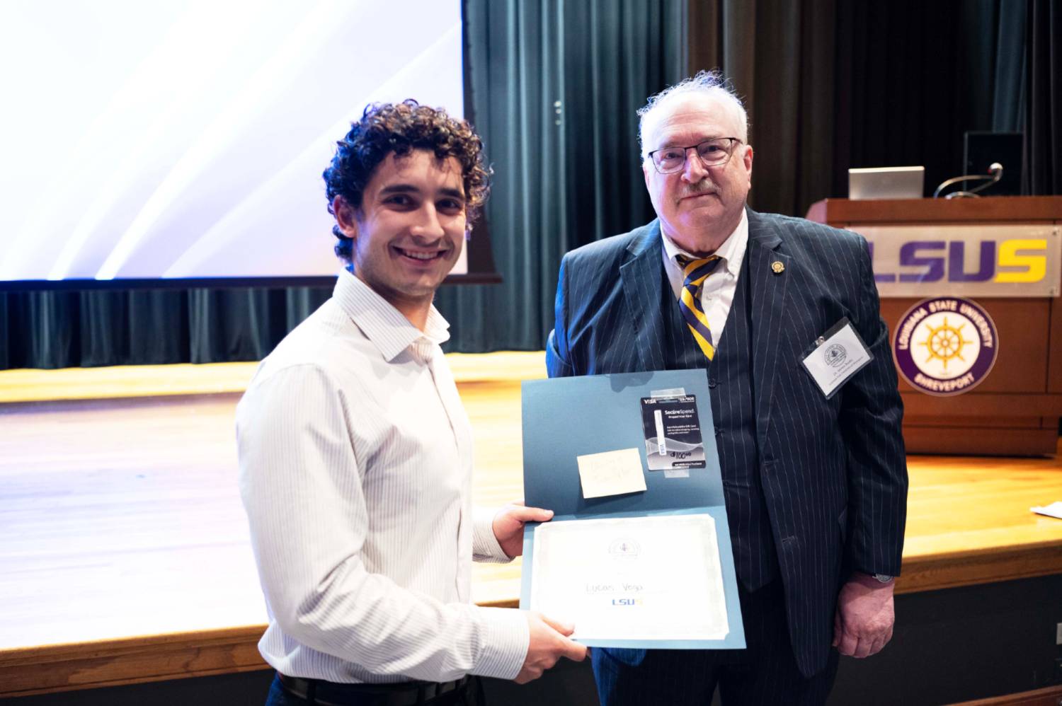 Vega and LSUS Representative Presenting the Award