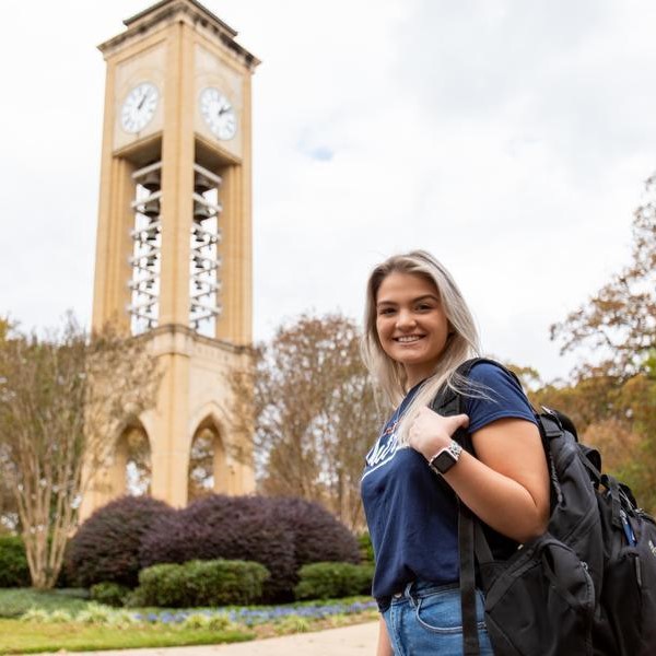 student in front of Riter Tower