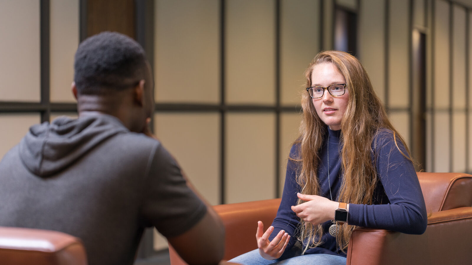 A male and a female student have a conversation while seated at The University of Texas at Tyler