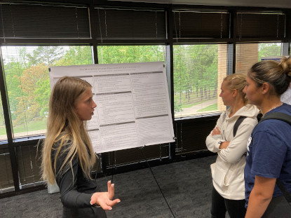 Student presenting her research poster.